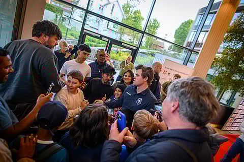 Magnus Carlsen being surrounded by young supporters in the ongoing Norway Chess meet