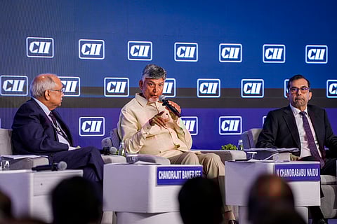 Andhra Pradesh Chief Minister N Chandrababu Naidu speaks as CII Director General Chandrajit Banerjee looks on during CII Annual Business Summit 2025, in New Delhi, Friday, May 30, 2025