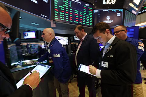 Traders work on the floor of the New York Stock Exchange (NYSE) 