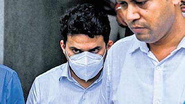 ED deputy director Chintan Raghuvanshi (wearing mask) comes out of the court complex after his arrest on Friday.