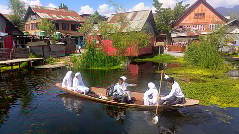 Hussain rows a boat with his friends to reach their school