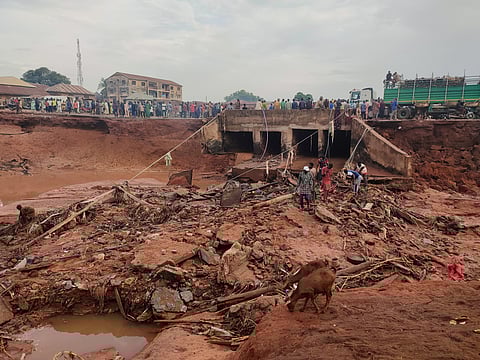People search in flooded area following a downpour in Mokwa, Nigeria, Friday, May 30, 2025. 