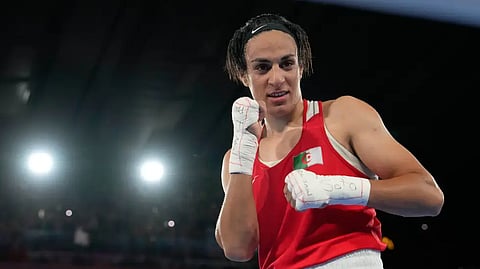 Algeria’s Imane Khelif poses after defeating China’s Yang Liu to win gold in their women’s 66 kg final boxing match at the 2024 Summer Olympics, Friday, Aug. 9, 2024, in Paris, France.