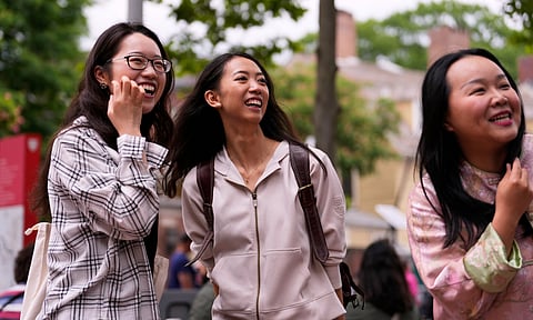 Yurong "Luanna" Jiang, center, who delivered a speech at her Harvard University commencement, jokes with her college friends Helen Ji, left, and Cynthia Luo, Friday, May 30, 2025, in Cambridge, Mass.