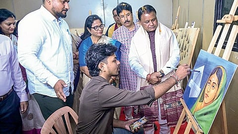 Chief Minister Mohan Charan Majhi looks at a painting of Rani Ahilyabai.
