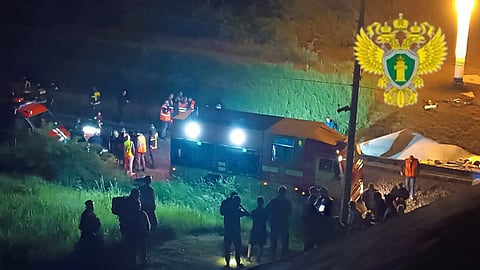 This handout photograph taken and released by the Moscow Interregional Transport Prosecutor's Office early on June 1, 2025 shows Russian law enforcement officers working at the site of a bridge collapse in the Vygonichi district of the Bryansk region. 