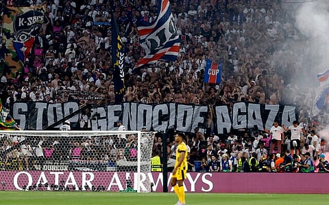 Fans hold a giant banner reading "Stop genocide in Gaza" during the UEFA Champions League final soccer match between Paris Saint-Germain (PSG) and Inter Milan in Munich, southern Germany, on May 31, 2025.