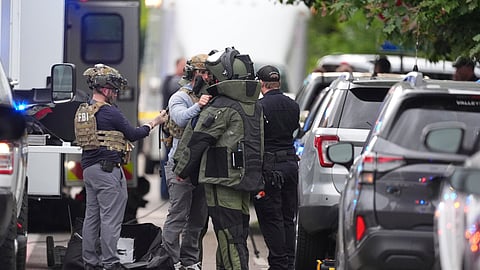 Law enforcement officials dress up in protective gear to investigative an attack on the Pearl Street Mall, Sunday, June 1, 2025, in Boulder, Colo.