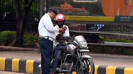 Traffic police conduct checks in New Delhi for insurance papers of vehicles.
