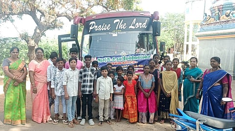 Students and teachers from the ADW school stand in front of the hired bus, arranged by the school and community to ensure safer and more reliable transport amid the lack of direct public bus access.