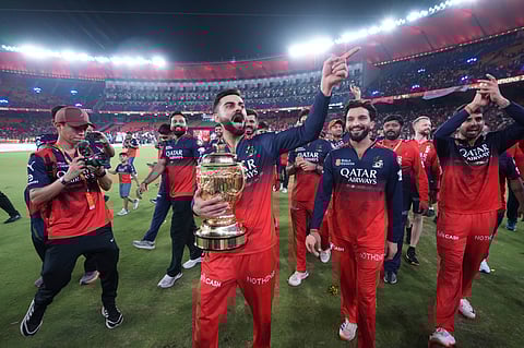 Virat Kohli and his teammates celebrate their IPL triumph at the Narendra Modi Stadium in Ahmedabad on Tuesday