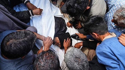 Palestinians mourn over the body of Reem Al-Akhras who was killed while heading to a Gaza aid hub, during her funeral at the Nasser Hospital in Khan Younis, southern Gaza Strip, Tuesday, June 3, 2025