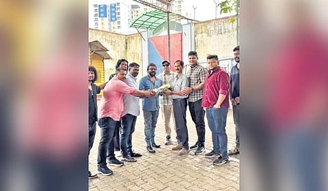 The gangsters presenting a bouquet to O J Thomas at his farewell function 