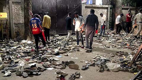 A number of shoes and slippers lying outside Chinnaswamy Stadium after a stampede during Royal Challengers Bangalore (RCB)'s victory celebrations, in Bengaluru on Wednesday. 