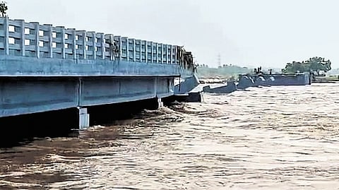 The bridge built over Thenpennai river was washed away by floodwaters; PWD claimed that water levels were triple the maximum discharge levels. 