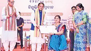 Chief Minister Mohan Charan Majhi handing over appointment letter to a newly-recruited official 