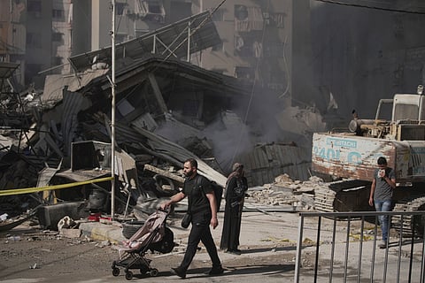 Citizens inspect the destruction after Israeli army strikes in the Dahiyeh suburb of Beirut, Lebanon, Friday, June 6, 2025.