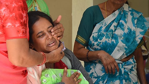 A woman consoles the mother of 14-year-old Divyanshi, who was one of the victims in Wednesday’s stampede, at their Yelahanka residence in Bengaluru, on Thursday