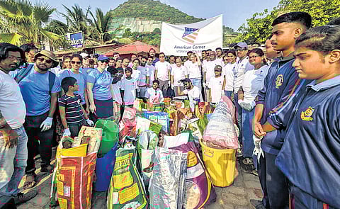Jennifer Larson, US Consul General in Hyderabad, takes part in a clean-up drive organised by AU American Corner at Rushikonda Beach in Visakhapatnam on Saturday 
