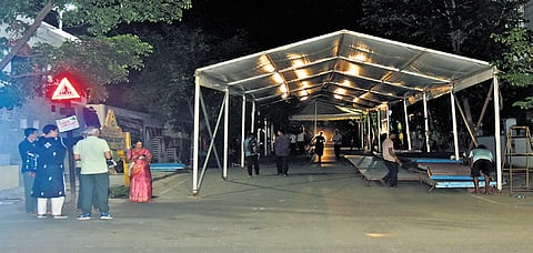 Workers remove a pandal that led to traffic disruptions on 4th Main, 13th Cross, Malleswaram road, on Saturday 