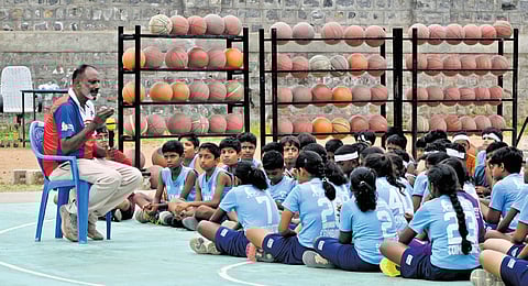 Irudhayaraj coaching students at YMCA basketball court in Coimbatore city 