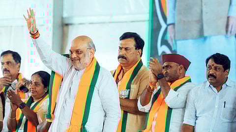 Union Home Minister Amit Shah waves to the gathering during the Tamil Nadu State, District and Mandal-level functionaries meeting in Madurai on Sunday. State BJP President Nainar Nagendran also seen