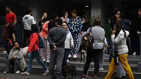 People remain on the street after an earthquake in Bogota on June 8, 2025. A powerful, shallow 6.3-magnitude earthquake shook the Colombian capital of Bogota early Saturday