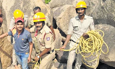 Police personnel with Parv Assat after pulling him up from a cave at Matanga Hill near Hampi on Sunday