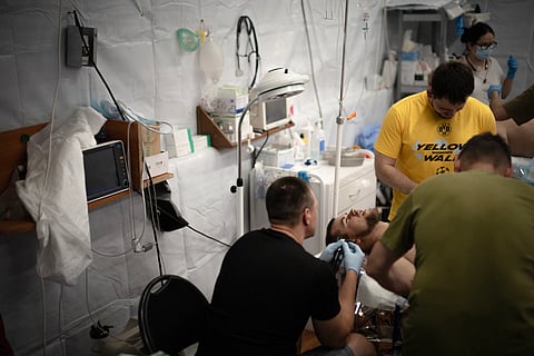 Ukrainian doctors treat a soldier injured by shrapnel from Russian explosive drones at a medical stabilisation centre of the 3rd Operational Brigade of the National Guard of Ukraine.