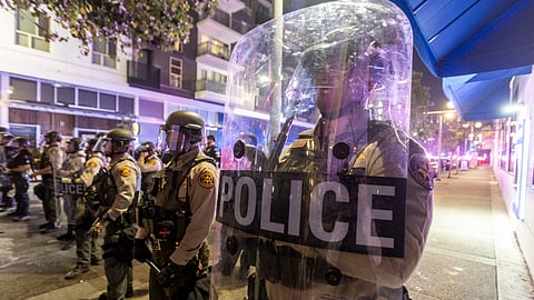 Police officers in riot gear stand during a demonstration following federal immigration operations in Los Angeles on June 9, 2025.