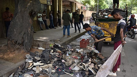 Civic workers seen clearing piles of abandoned footwear after the stampede at Chinnaswamy Stadium, which left 11 dead and several injured in Bengaluru, June 5, 2025.