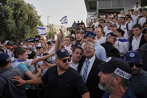 Surrounded by security guards, Israel's far-right National Security Minister, Itamar Ben-Gvir, center, participates in march marking Jerusalem Day on May 26 th.