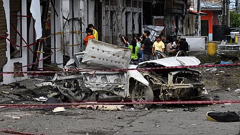 Bystanders look at destroyed buildings after a car exploded in front of the City Hall in Corinto, Cauca department, Colombia, on June 10, 2025