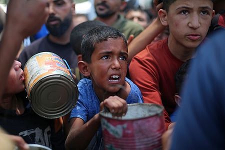 Demonstrators carrying Palestinian flags look on as the Ship to Gaza boat 'Handala' arrives at the port of Malmö, Sweden, Wednesday, May 8, 2024.