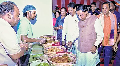 CM Mohan Charan Majhi checks out delicacies at a food stall in Vikas Mela