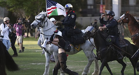 Los Angeles Metro police on horseback disperse protesters on Wednesday, June 11, 2025, in Los Angeles.