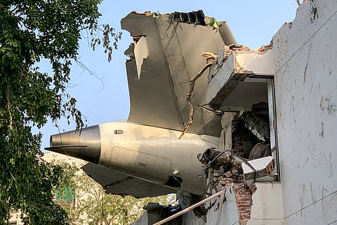 Officials inspect the wreckage of the London-bound Air India flight, which crashed on 12 June 2025, in Ahmedabad.
