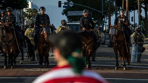 Police confront a protesters outside City Hall during protests over federal immigration enforcement raids on Wednesday, June 11, 2025, in Los Angeles. 
