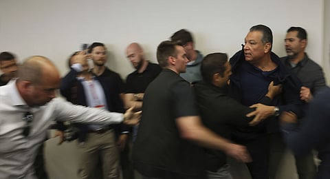 U.S. Sen. Alex Padilla, D-Calif., is pushed out of the room as Homeland Security Secretary Kristi Noem holds a news conference regarding the recent protests in Los Angeles on Thursday, June 12, 2025.