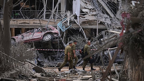 Israeli security forces inspect destroyed residential buildings that were hit by a missile fired from Iran, in Ramat Gan, near Tel Aviv, Israel, on Saturday, June 14, 2025.