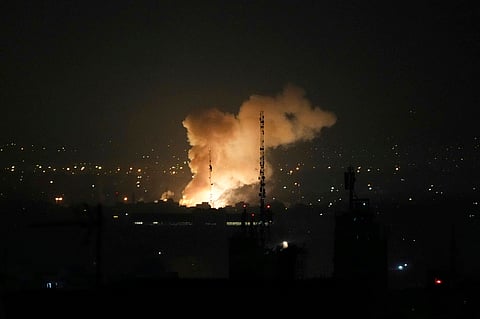 Responders work amid building rubble following a strike by an Iranian missile in the Israeli city of Bat Yam, south of Tel Aviv, early on June 15, 2025. Air raid sirens and booms rang out in Jerusalem and Tel Aviv early on June 15, AFP journalists said, as Israel and Iran exchanged fire for a third day.