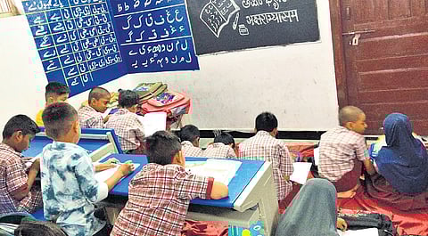 Students attend classes in a government school functioning from a rented building at Shaheenagar in the Old City on Saturday