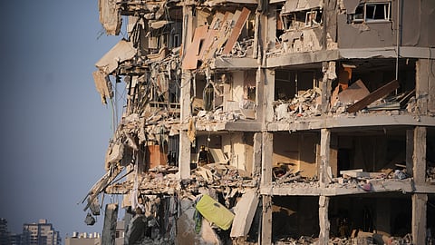 Israeli security forces inspect a destroyed building that was hit by a missile fired from Iran, near Tel Aviv, Israel, Sunday, June 15, 2025. 