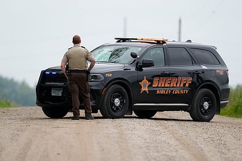 A Sibley County Sheriff's Deputy blocks the road where the suspect involved in the shooting of two state lawmakers vehicle was found Sunday, June 15, 2025, in Faxon Township, Minn. 