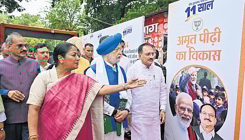 Union Minister Hardeep Singh Puri with Delhi BJP President Virendra Sachdeva and Chief Minister Rekha Gupta during the inauguration of an exhibition. 