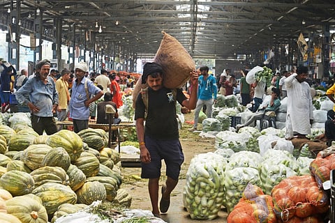 They load, they sweat, they survive,  but are still invisible in Delhi’s largest mandi