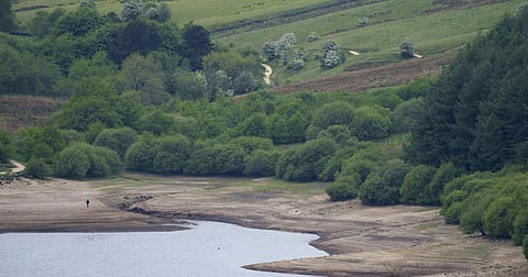 A member of the pubic walks on an exposed area of Scammonden Reservoir in West Yorkshire as England experiences a significant drought, with reservoir levels at 84% of capacity, Ripponden, England on May 19, 2025
