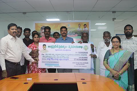 Director of Agriculture Dilli Rao releases a mega cheque alongside farmers at the Office of the Director of Agriculture in Amaravati on Wednesday. 