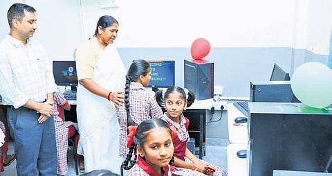 Panchayat Raj Minister Danasari Anasuya speaks to students after inaugurating a computer lab in the PM Shri Model School in Bandarupally village of Mulugu district