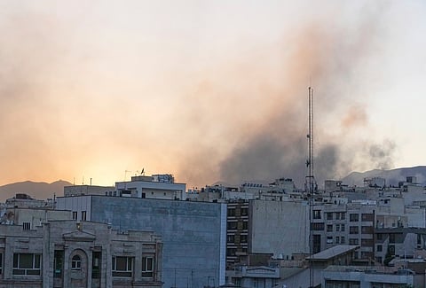 Smoke rises up after Israel's attack, in Tehran, Iran, Wednesday, June 18, 2025.